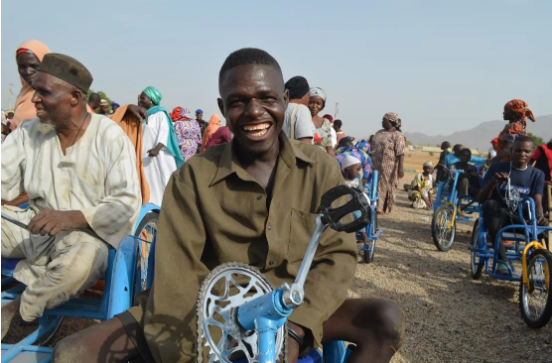 A beneficiary of Beautiful Gates on a wheelchair produced by the organisation